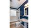 Bathroom featuring a tub, a tile window, and a white sink pedestal against blue walls at 148 Murray Hill Ne Ave, Atlanta, GA 30317