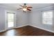Bedroom featuring wood floors, a ceiling fan, windows, and a door to the back deck at 148 Murray Hill Ne Ave, Atlanta, GA 30317