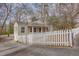 Well-kept home featuring a white picket fence and mature trees at 148 Murray Hill Ne Ave, Atlanta, GA 30317