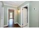 Hallway leading to a door and a separate room. Hardwood flooring can be seen through the doorway at 148 Murray Hill Ne Ave, Atlanta, GA 30317