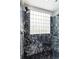 Beautiful tiled shower with glass block window bringing in plenty of natural light at 148 Murray Hill Ne Ave, Atlanta, GA 30317
