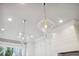 A modern kitchen design featuring hanging light fixtures and white cabinets, enhancing its elegant and airy atmosphere at 3715 Peachtree Ne Rd # 2, Atlanta, GA 30319