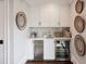 Cozy wet bar area with white cabinets, beverage fridge, and decorative accents for stylish entertaining at 3715 Peachtree Ne Rd # 2, Atlanta, GA 30319