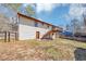 Back exterior of home with deck and steps in fenced backyard with sparse grass at 5508 Hadrian Ct, Lithonia, GA 30058