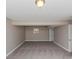 Spacious basement featuring neutral paint, gray carpet and a window with natural light at 5508 Hadrian Ct, Lithonia, GA 30058