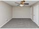 Bright bedroom featuring neutral walls, gray carpet and a ceiling fan with lighting at 5508 Hadrian Ct, Lithonia, GA 30058