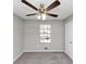 Bedroom with ceiling fan, neutral carpet, and a window at 5508 Hadrian Ct, Lithonia, GA 30058
