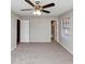 Cozy bedroom featuring a large window, neutral walls, gray carpet and a ceiling fan with lighting at 5508 Hadrian Ct, Lithonia, GA 30058