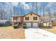 Charming split-level home with a two-car garage, brick accents, and landscaped front yard at 5508 Hadrian Ct, Lithonia, GA 30058