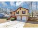 Charming split-level home with a two-car garage, brick accents, and landscaped front yard at 5508 Hadrian Ct, Lithonia, GA 30058