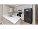 Updated kitchen features white cabinets, black appliances, and modern countertops at 5508 Hadrian Ct, Lithonia, GA 30058