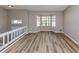 Bright living room features hardwood floors, a bay window, and comfortable seating area at 5508 Hadrian Ct, Lithonia, GA 30058
