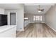 Open living room with vaulted ceiling, large windows, and modern vinyl plank flooring at 5508 Hadrian Ct, Lithonia, GA 30058