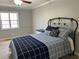 Cozy bedroom with neutral colors, a comfortable-looking bed, and a bright window at 601 Brass Key Ct, Lawrenceville, GA 30046