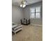 Bright, carpeted room featuring a crib and a bed next to a bright window at 601 Brass Key Ct, Lawrenceville, GA 30046