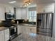 Modern kitchen with granite countertops, stainless steel appliances, and ample cabinet space at 601 Brass Key Ct, Lawrenceville, GA 30046
