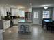 Spacious kitchen featuring modern appliances, island with seating, and adjacent dining area at 601 Brass Key Ct, Lawrenceville, GA 30046