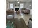 Cozy living room with fireplace, comfortable seating, and natural light from large windows at 601 Brass Key Ct, Lawrenceville, GA 30046