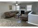 Cozy living room with neutral tones, fireplace, and a plush sofa and chaise lounge at 601 Brass Key Ct, Lawrenceville, GA 30046