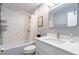 Bathroom with a shower-tub combination, modern vanity, decorative mirror, and elegant tiling at 1901 Cumberland Ct, Smyrna, GA 30080