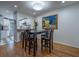 Bright dining area with hardwood floors adjacent to the kitchen, complete with an artful light fixture and furniture at 1901 Cumberland Ct, Smyrna, GA 30080