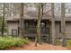 Exterior view of a house with a wooden porch, surrounded by trees and natural foliage at 1901 Cumberland Ct, Smyrna, GA 30080