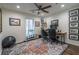 Comfortable home office features a ceiling fan, a colorful rug, and built-in shelving for storage at 1901 Cumberland Ct, Smyrna, GA 30080