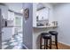 View of the kitchen with white cabinetry, stainless appliances, breakfast bar and two bar stools at 1901 Cumberland Ct, Smyrna, GA 30080