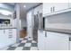 Clean kitchen boasts white cabinetry, stainless steel appliances, and a classic checkered tile floor at 1901 Cumberland Ct, Smyrna, GA 30080