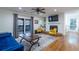 Bright living room featuring a ceiling fan, fireplace, hardwood floors, and sliding door to a balcony at 1901 Cumberland Ct, Smyrna, GA 30080