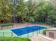 A well-maintained outdoor community tennis court is surrounded by lush trees at 1901 Cumberland Ct, Smyrna, GA 30080