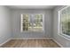 Sunlit bedroom with hardwood floors, large windows, and neutral paint at 2135 N Forest Trl, Dunwoody, GA 30338