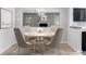 Staged dining room featuring modern chandelier and seating for six at 2135 N Forest Trl, Dunwoody, GA 30338