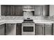 Modern kitchen featuring stainless steel appliances, backsplash, and granite counters at 2135 N Forest Trl, Dunwoody, GA 30338