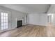 Bright and airy living room with a fireplace, hardwood floors, and neutral decor at 2135 N Forest Trl, Dunwoody, GA 30338
