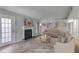 Spacious living room featuring a fireplace, hardwood floors, and ample natural light at 2135 N Forest Trl, Dunwoody, GA 30338