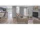 Bright living room featuring a fireplace, wood floors, and open access to the kitchen at 2135 N Forest Trl, Dunwoody, GA 30338
