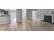 Open-concept living room with a fireplace, light-colored walls, and wood floors at 2135 N Forest Trl, Dunwoody, GA 30338