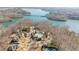 Aerial view showcases homes near a lake, pools, and docks, ideal for waterfront living and recreational activities at 6455 Quiet Cove Rd, Cumming, GA 30041