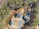 Stunning aerial view of a modern home with a pool, lush backyard, and mature trees surrounding the property at 6455 Quiet Cove Rd, Cumming, GA 30041