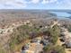 Expansive aerial view of a lakeside community showing large homes with mature landscaping and lake views at 6455 Quiet Cove Rd, Cumming, GA 30041