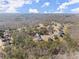 Neighborhood aerial view showcasing sprawling homes amidst a beautiful backdrop of mature trees and natural surroundings at 6455 Quiet Cove Rd, Cumming, GA 30041