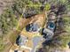 Aerial view of modern home showing approximate property lines, pool, lush backyard, and mature trees surrounding the property at 6455 Quiet Cove Rd, Cumming, GA 30041