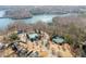 Neighborhood aerial view featuring large homes with swimming pools and tennis courts with lake views at 6455 Quiet Cove Rd, Cumming, GA 30041
