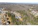 An aerial view of a tranquil neighborhood featuring wooded lots, well-maintained homes, and scenic surroundings at 6455 Quiet Cove Rd, Cumming, GA 30041