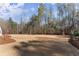Spacious backyard with lush lawn area, mature trees, and a charming fence at 6455 Quiet Cove Rd, Cumming, GA 30041