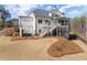 Expansive backyard featuring a hot tub with pergola and an outdoor entertaining area at 6455 Quiet Cove Rd, Cumming, GA 30041