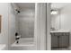Elegant bathroom with a shower-tub combo and modern fixtures at 6455 Quiet Cove Rd, Cumming, GA 30041