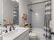 This modern bathroom offers a shower over tub, white subway tiles, and neutral colors at 6455 Quiet Cove Rd, Cumming, GA 30041