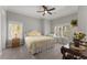 Bright bedroom featuring windows, a comfortable bed, and cozy sitting area at 6455 Quiet Cove Rd, Cumming, GA 30041